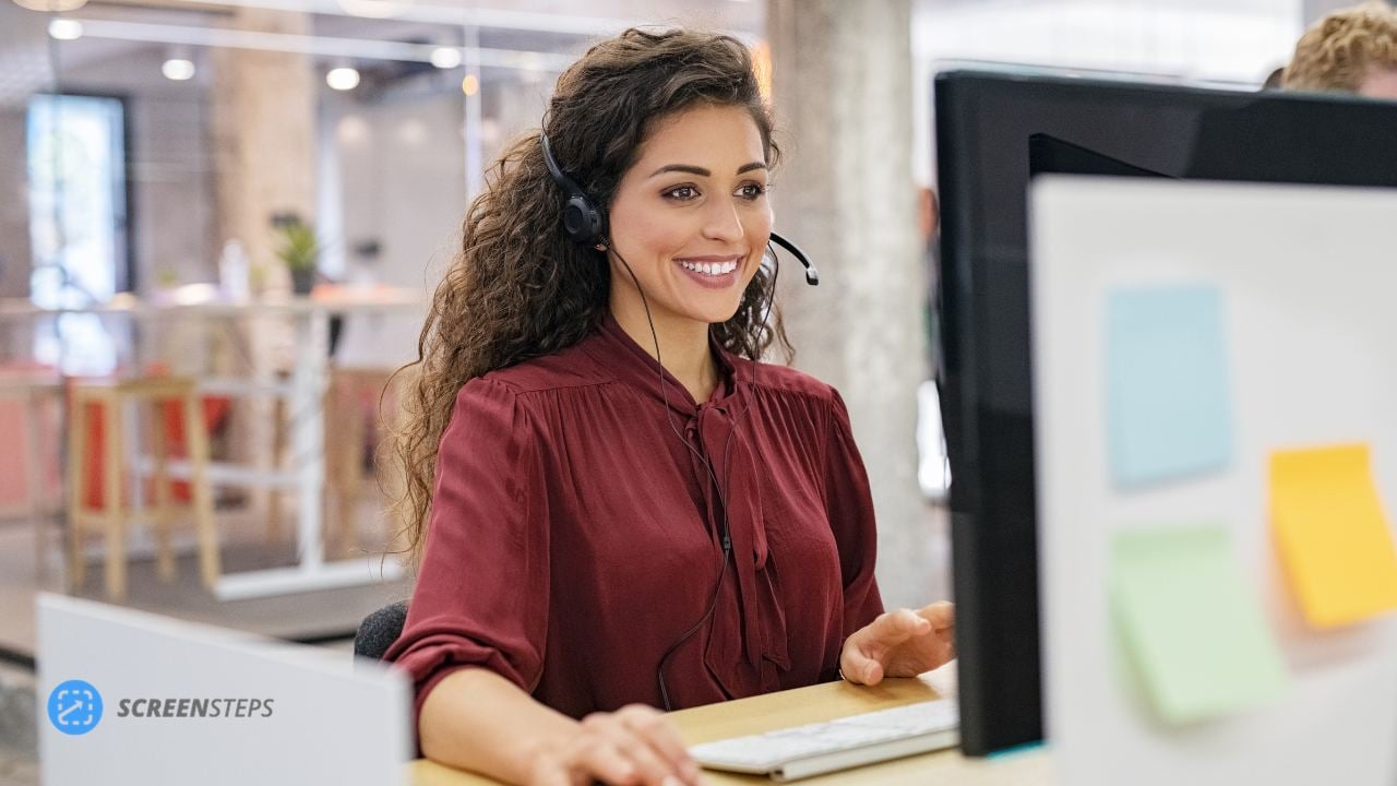 Call center agent takes a call using her knowledge base software.